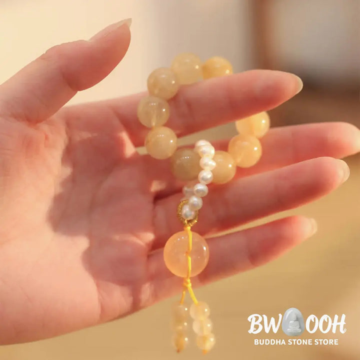 BWOOOH Citrine Peace Buckle Wrist Mala featuring polished 12mm citrine beads, a serene peace buckle symbol, delicate pearl and sakura agate accents, strung on premium material for deep mindfulness and attracting prosperity. - View 4
