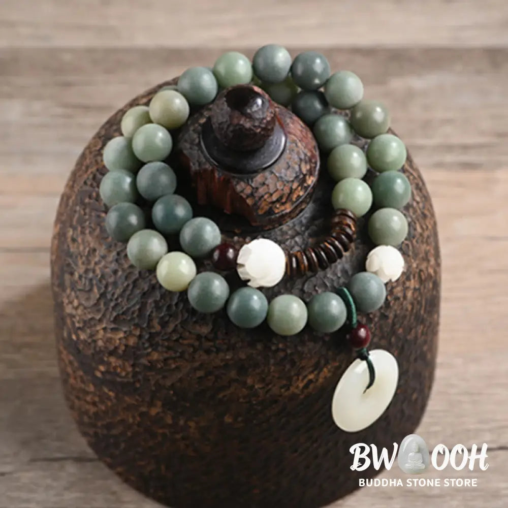 BWOOOH Cyan Bodhi Seed Lotus Jade Peace Buckle Wisdom Double Wrap Bracelet, featuring 10mm vibrant cyan bodhi seeds, serene jade, and intricate small leaf red sandalwood beads. Symbolizes enlightenment, inner peace, and spiritual balance for mindful practice and daily wear. - View 7