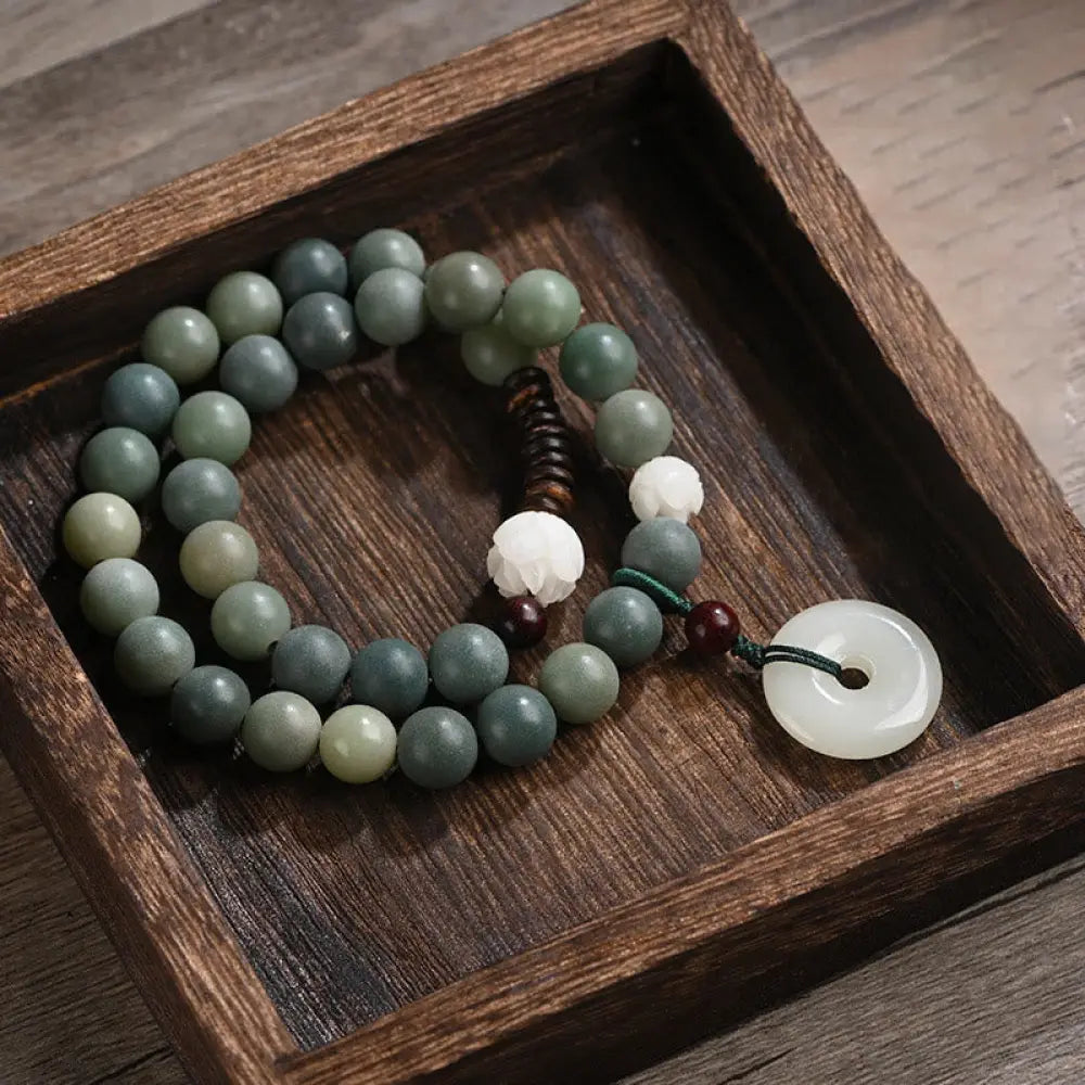 BWOOOH Cyan Bodhi Seed Lotus Jade Peace Buckle Wisdom Double Wrap Bracelet, featuring 10mm vibrant cyan bodhi seeds, serene jade, and intricate small leaf red sandalwood beads. Symbolizes enlightenment, inner peace, and spiritual balance for mindful practice and daily wear.