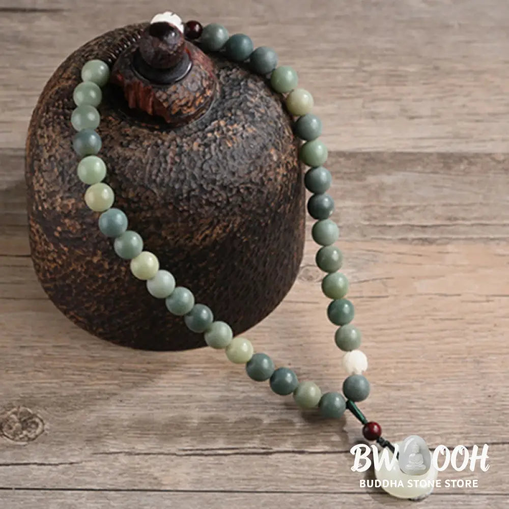 BWOOOH Cyan Bodhi Seed Lotus Jade Peace Buckle Wisdom Double Wrap Bracelet, featuring 10mm vibrant cyan bodhi seeds, serene jade, and intricate small leaf red sandalwood beads. Symbolizes enlightenment, inner peace, and spiritual balance for mindful practice and daily wear. - View 8