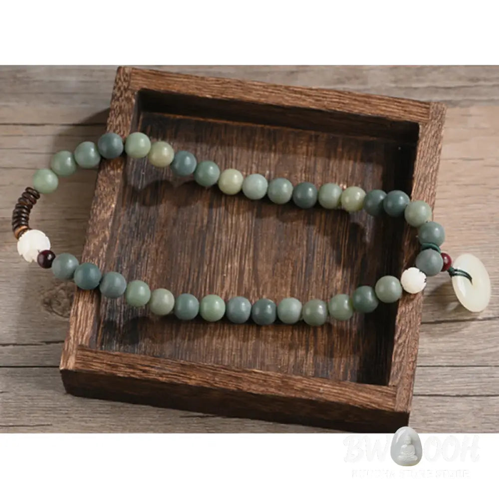 BWOOOH Cyan Bodhi Seed Lotus Jade Peace Buckle Wisdom Double Wrap Bracelet, featuring 10mm vibrant cyan bodhi seeds, serene jade, and intricate small leaf red sandalwood beads. Symbolizes enlightenment, inner peace, and spiritual balance for mindful practice and daily wear. - View 15