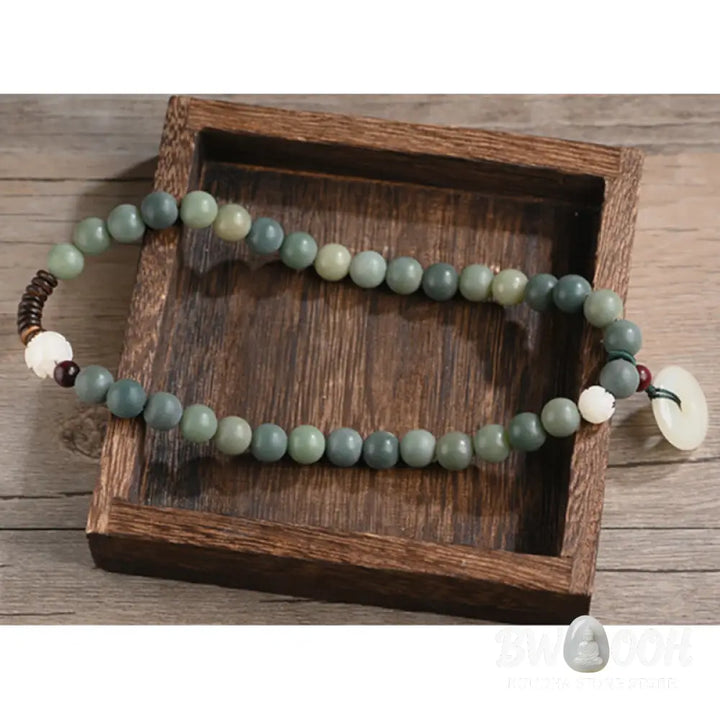 BWOOOH Cyan Bodhi Seed Lotus Jade Peace Buckle Wisdom Double Wrap Bracelet, featuring 10mm vibrant cyan bodhi seeds, serene jade, and intricate small leaf red sandalwood beads. Symbolizes enlightenment, inner peace, and spiritual balance for mindful practice and daily wear. - View 15