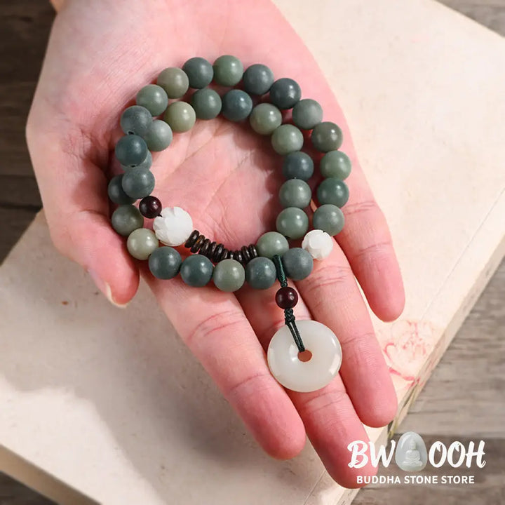 BWOOOH Cyan Bodhi Seed Lotus Jade Peace Buckle Wisdom Double Wrap Bracelet, featuring 10mm vibrant cyan bodhi seeds, serene jade, and intricate small leaf red sandalwood beads. Symbolizes enlightenment, inner peace, and spiritual balance for mindful practice and daily wear. - View 4