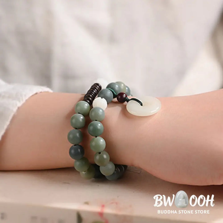 BWOOOH Cyan Bodhi Seed Lotus Jade Peace Buckle Wisdom Double Wrap Bracelet, featuring 10mm vibrant cyan bodhi seeds, serene jade, and intricate small leaf red sandalwood beads. Symbolizes enlightenment, inner peace, and spiritual balance for mindful practice and daily wear. - View 5