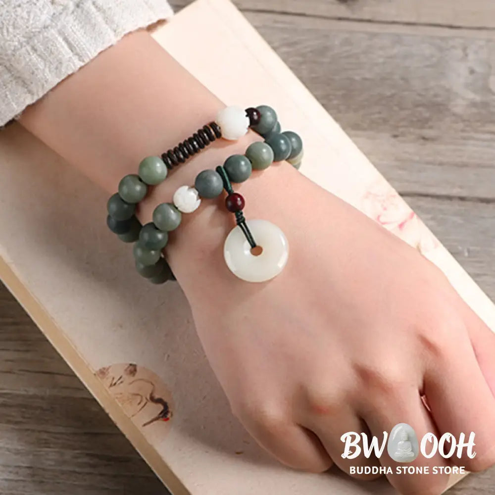 BWOOOH Cyan Bodhi Seed Lotus Jade Peace Buckle Wisdom Double Wrap Bracelet, featuring 10mm vibrant cyan bodhi seeds, serene jade, and intricate small leaf red sandalwood beads. Symbolizes enlightenment, inner peace, and spiritual balance for mindful practice and daily wear. - View 6