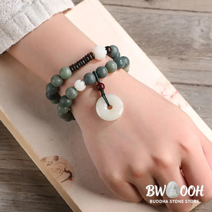 BWOOOH Cyan Bodhi Seed Lotus Jade Peace Buckle Wisdom Double Wrap Bracelet, featuring 10mm vibrant cyan bodhi seeds, serene jade, and intricate small leaf red sandalwood beads. Symbolizes enlightenment, inner peace, and spiritual balance for mindful practice and daily wear. - View 6