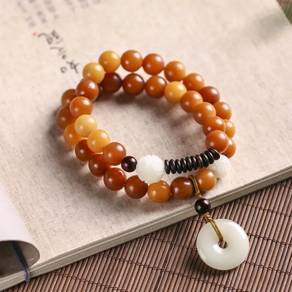 BWOOOH Cyan Bodhi Seed Lotus Jade Peace Buckle Wisdom Double Wrap Bracelet, featuring 10mm vibrant cyan bodhi seeds, serene jade, and intricate small leaf red sandalwood beads. Symbolizes enlightenment, inner peace, and spiritual balance for mindful practice and daily wear. - View 16
