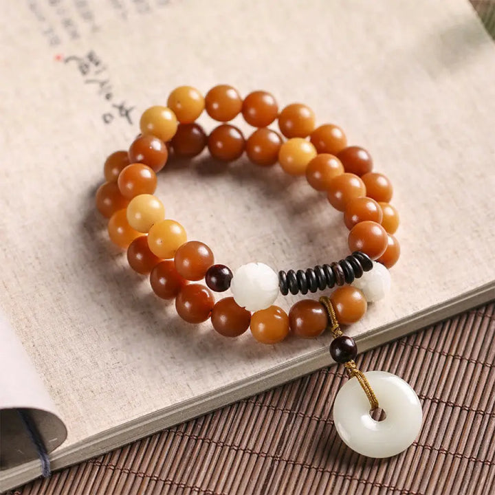 BWOOOH Cyan Bodhi Seed Lotus Jade Peace Buckle Wisdom Double Wrap Bracelet, featuring 10mm vibrant cyan bodhi seeds, serene jade, and intricate small leaf red sandalwood beads. Symbolizes enlightenment, inner peace, and spiritual balance for mindful practice and daily wear. - View 16
