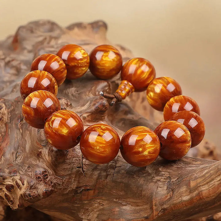 BWOOOH Golden Sea Willow Success Positive Bracelet Mala, handcrafted from synthetic Golden Sea Willow. Features rich golden hues, polished beads (various sizes like 15mm, 18mm, 108-bead configurations), and an elastic string, worn for mindfulness, prosperity, and spiritual balance.