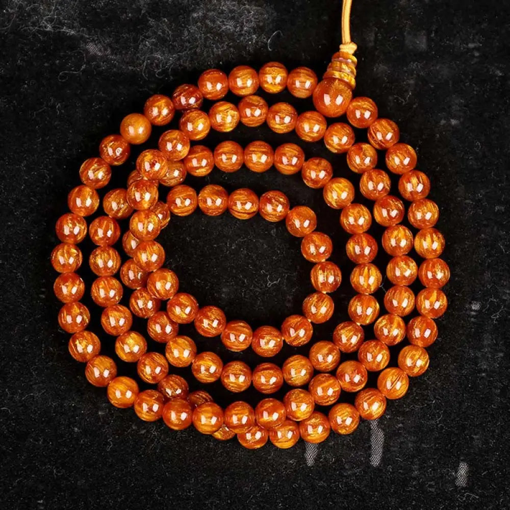 BWOOOH Golden Sea Willow Success Positive Bracelet Mala, handcrafted from synthetic Golden Sea Willow. Features rich golden hues, polished beads (various sizes like 15mm, 18mm, 108-bead configurations), and an elastic string, worn for mindfulness, prosperity, and spiritual balance. - View 16