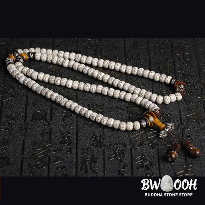 A close-up of a BWOOOH Handmade Tibetan Tiger Eye Bodhi Seed Peace Bracelet, featuring 108 natural variegated Bodhi seeds alternating with golden-brown Tiger Eye beads, symbolizing spiritual protection and inner peace for mindful wearers. - View 4