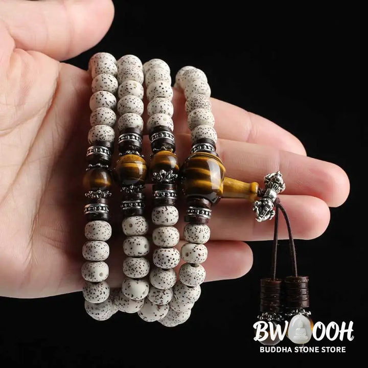 A close-up of a BWOOOH Handmade Tibetan Tiger Eye Bodhi Seed Peace Bracelet, featuring 108 natural variegated Bodhi seeds alternating with golden-brown Tiger Eye beads, symbolizing spiritual protection and inner peace for mindful wearers. - View 7