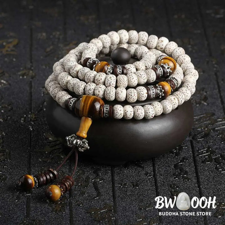 A close-up of a BWOOOH Handmade Tibetan Tiger Eye Bodhi Seed Peace Bracelet, featuring 108 natural variegated Bodhi seeds alternating with golden-brown Tiger Eye beads, symbolizing spiritual protection and inner peace for mindful wearers. - View 2
