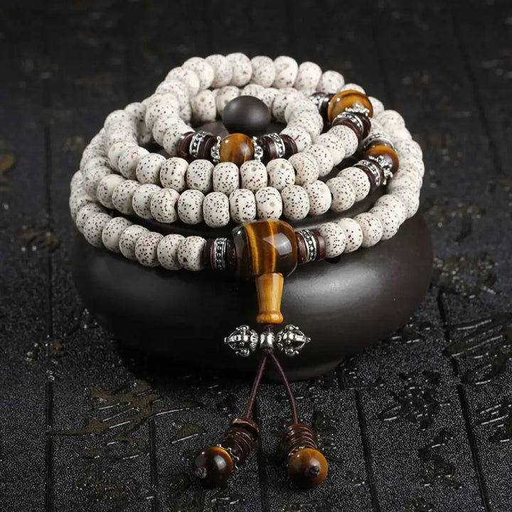 A close-up of a BWOOOH Handmade Tibetan Tiger Eye Bodhi Seed Peace Bracelet, featuring 108 natural variegated Bodhi seeds alternating with golden-brown Tiger Eye beads, symbolizing spiritual protection and inner peace for mindful wearers.