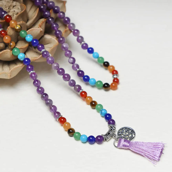 A BWOOOH 108-bead mala featuring 6mm polished Amethyst, lustrous Tiger Eye, and grounding Volcanic stones, styled as a multilayer bracelet and necklace for meditation and 7 Chakra healing.