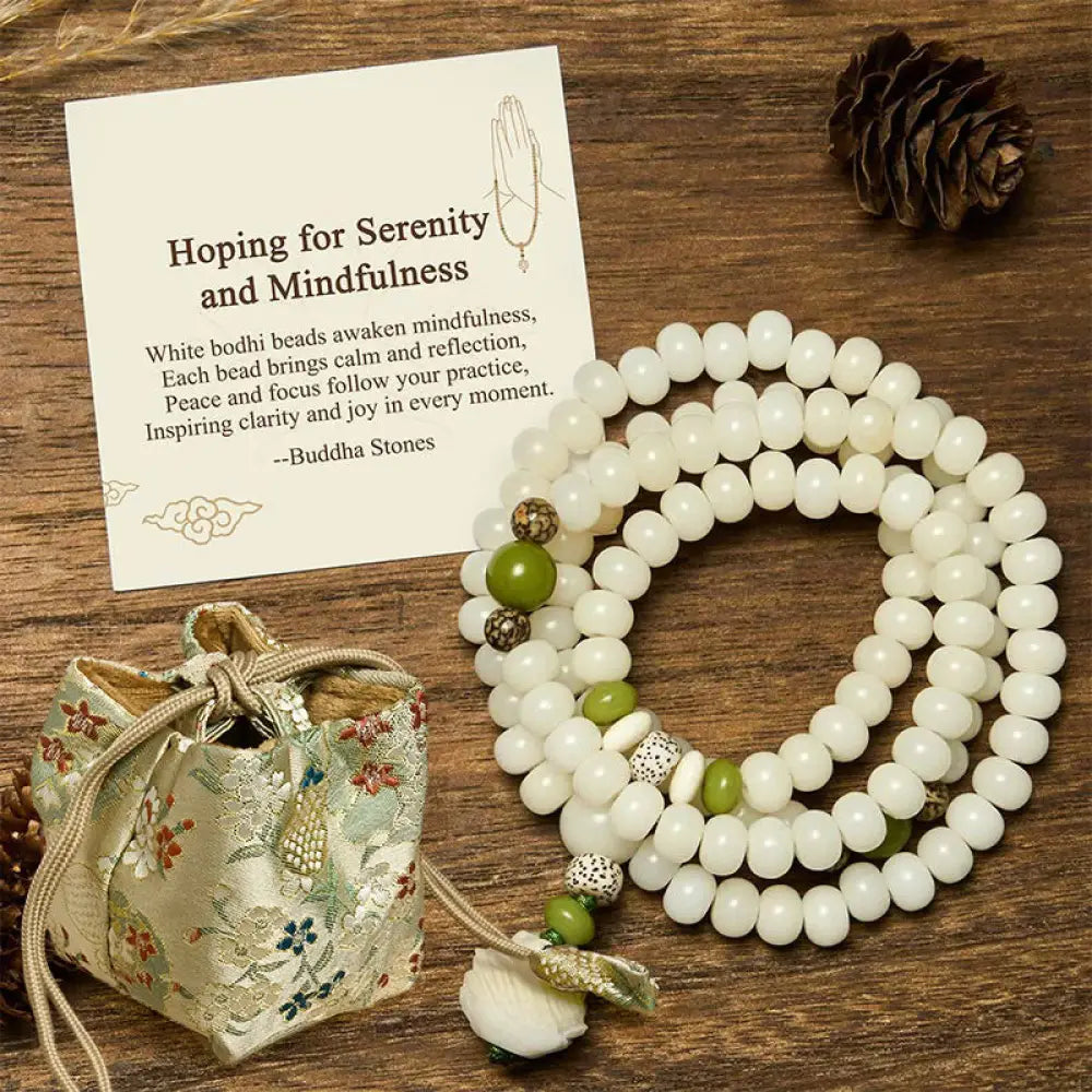BWOOOH Bodhi Lotus Mala necklace, handcrafted with 108 natural Bodhi seeds (mix of 6x8mm and 8x10mm) and a central, delicate Lotus flower pendant. This spiritual meditation tool, designed for serenity and mindfulness, is artfully displayed with its accompanying gift message card. Promotes enlightenment, peace, and resilience. - View 7