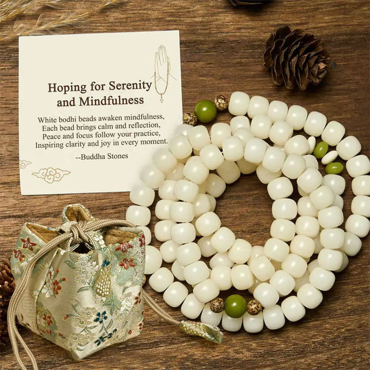 BWOOOH Bodhi Lotus Mala necklace, handcrafted with 108 natural Bodhi seeds (mix of 6x8mm and 8x10mm) and a central, delicate Lotus flower pendant. This spiritual meditation tool, designed for serenity and mindfulness, is artfully displayed with its accompanying gift message card. Promotes enlightenment, peace, and resilience. - View 10