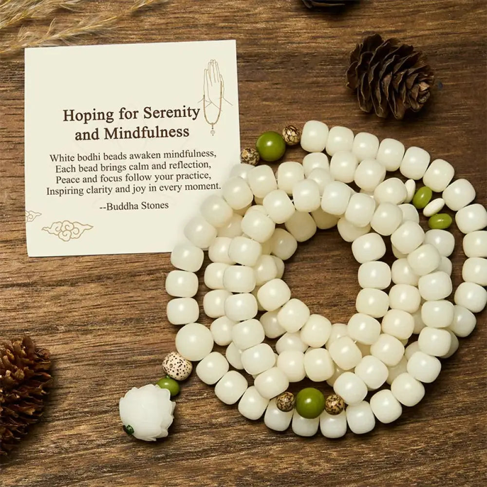 BWOOOH Bodhi Lotus Mala necklace, handcrafted with 108 natural Bodhi seeds (mix of 6x8mm and 8x10mm) and a central, delicate Lotus flower pendant. This spiritual meditation tool, designed for serenity and mindfulness, is artfully displayed with its accompanying gift message card. Promotes enlightenment, peace, and resilience. - View 2