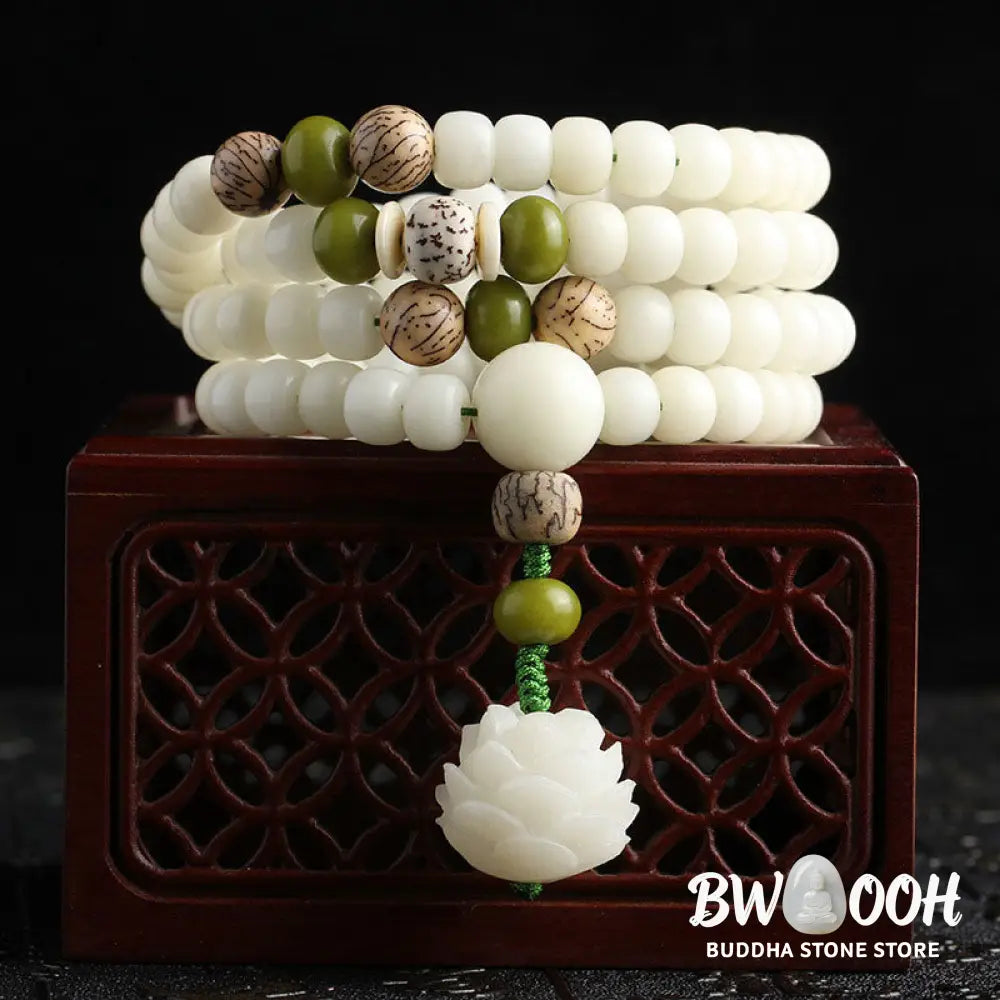 BWOOOH Bodhi Lotus Mala necklace, handcrafted with 108 natural Bodhi seeds (mix of 6x8mm and 8x10mm) and a central, delicate Lotus flower pendant. This spiritual meditation tool, designed for serenity and mindfulness, is artfully displayed with its accompanying gift message card. Promotes enlightenment, peace, and resilience. - View 12