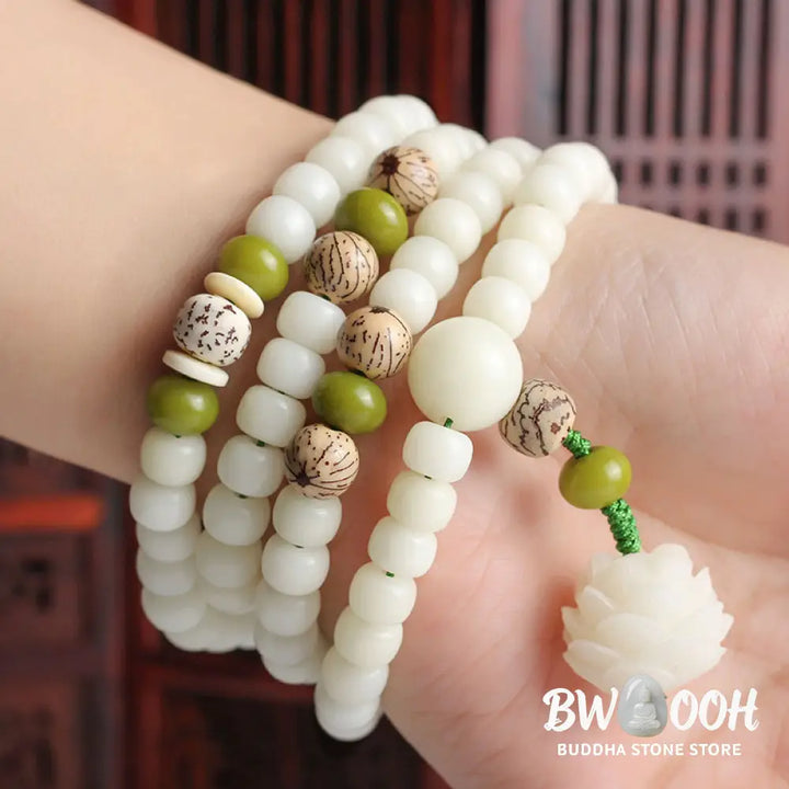 BWOOOH Bodhi Lotus Mala necklace, handcrafted with 108 natural Bodhi seeds (mix of 6x8mm and 8x10mm) and a central, delicate Lotus flower pendant. This spiritual meditation tool, designed for serenity and mindfulness, is artfully displayed with its accompanying gift message card. Promotes enlightenment, peace, and resilience. - View 16