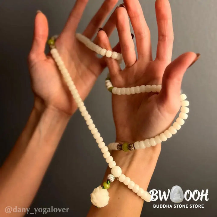 BWOOOH Bodhi Lotus Mala necklace, handcrafted with 108 natural Bodhi seeds (mix of 6x8mm and 8x10mm) and a central, delicate Lotus flower pendant. This spiritual meditation tool, designed for serenity and mindfulness, is artfully displayed with its accompanying gift message card. Promotes enlightenment, peace, and resilience. - View 28