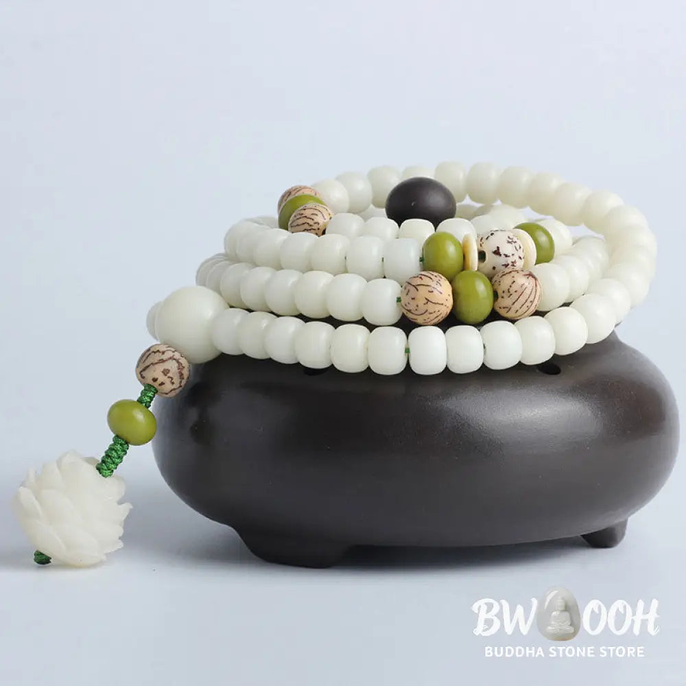 BWOOOH Bodhi Lotus Mala necklace, handcrafted with 108 natural Bodhi seeds (mix of 6x8mm and 8x10mm) and a central, delicate Lotus flower pendant. This spiritual meditation tool, designed for serenity and mindfulness, is artfully displayed with its accompanying gift message card. Promotes enlightenment, peace, and resilience. - View 26