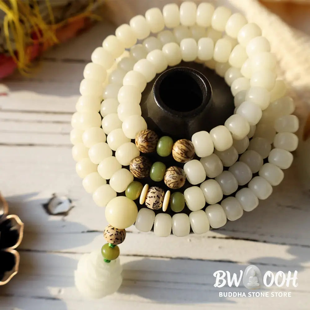 BWOOOH Bodhi Lotus Mala necklace, handcrafted with 108 natural Bodhi seeds (mix of 6x8mm and 8x10mm) and a central, delicate Lotus flower pendant. This spiritual meditation tool, designed for serenity and mindfulness, is artfully displayed with its accompanying gift message card. Promotes enlightenment, peace, and resilience. - View 15