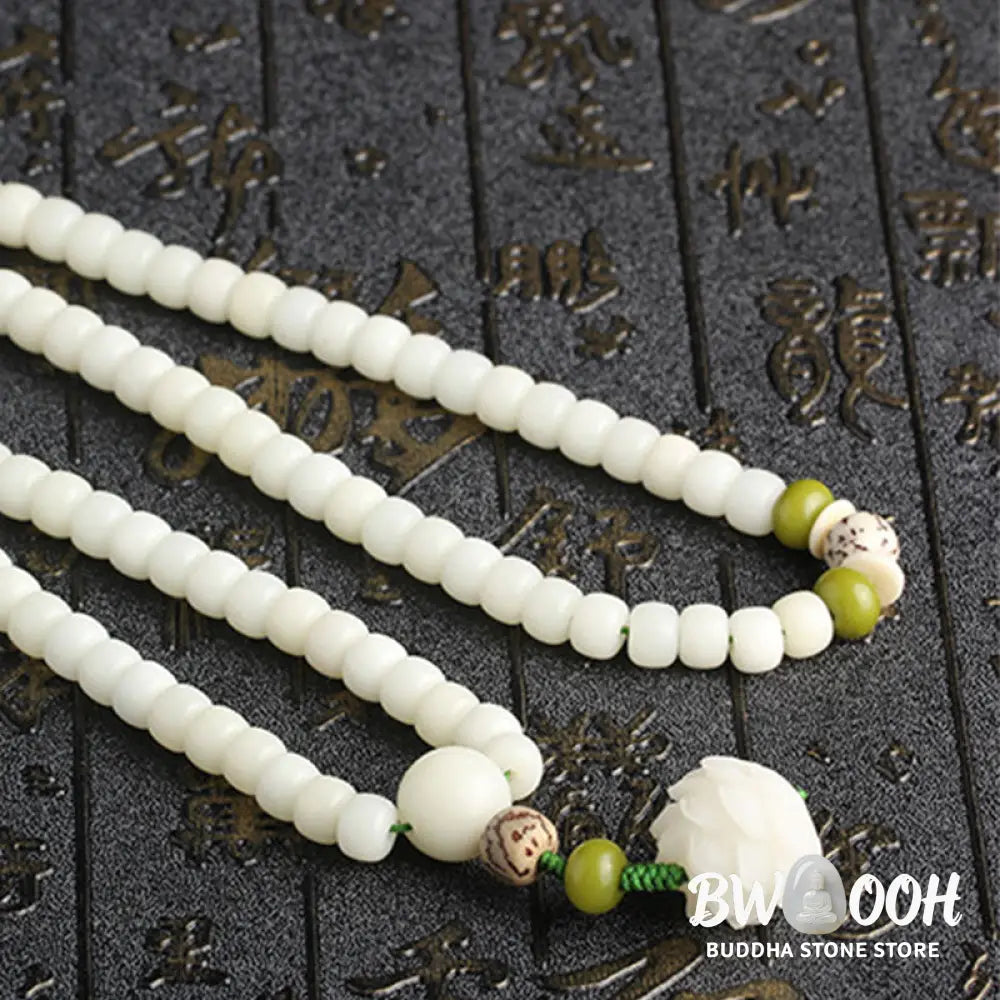 BWOOOH Bodhi Lotus Mala necklace, handcrafted with 108 natural Bodhi seeds (mix of 6x8mm and 8x10mm) and a central, delicate Lotus flower pendant. This spiritual meditation tool, designed for serenity and mindfulness, is artfully displayed with its accompanying gift message card. Promotes enlightenment, peace, and resilience. - View 27