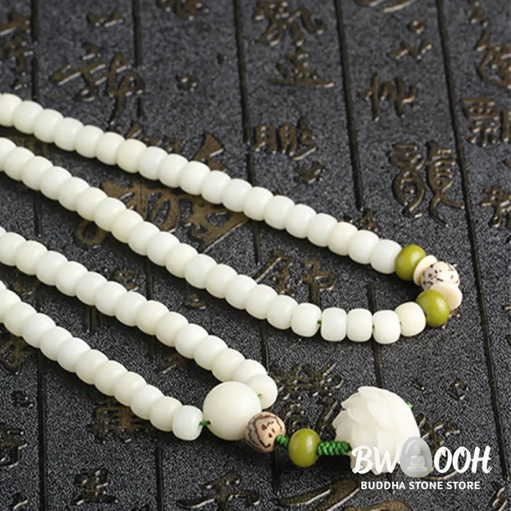 BWOOOH Bodhi Lotus Mala necklace, handcrafted with 108 natural Bodhi seeds (mix of 6x8mm and 8x10mm) and a central, delicate Lotus flower pendant. This spiritual meditation tool, designed for serenity and mindfulness, is artfully displayed with its accompanying gift message card. Promotes enlightenment, peace, and resilience. - View 27