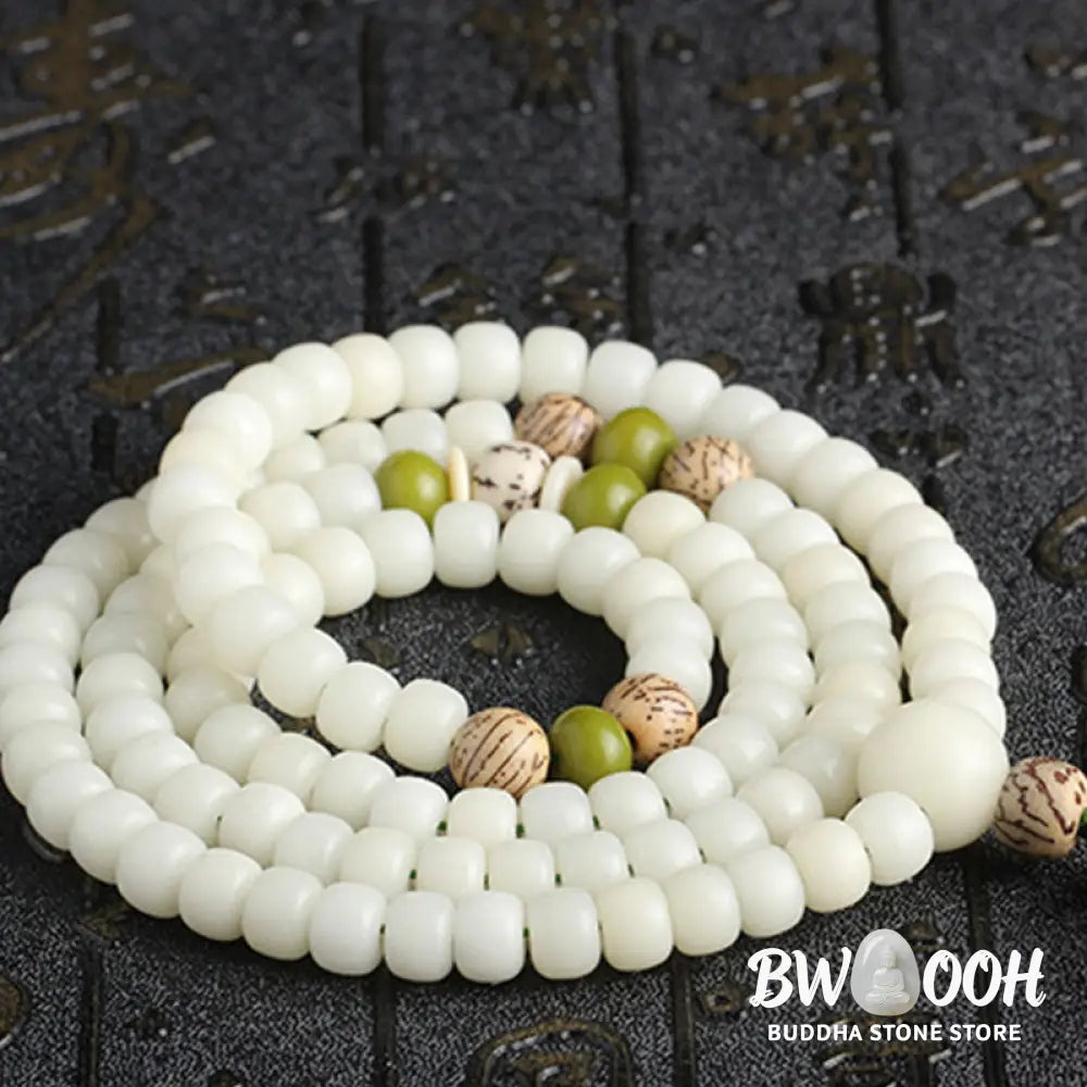 BWOOOH Bodhi Lotus Mala necklace, handcrafted with 108 natural Bodhi seeds (mix of 6x8mm and 8x10mm) and a central, delicate Lotus flower pendant. This spiritual meditation tool, designed for serenity and mindfulness, is artfully displayed with its accompanying gift message card. Promotes enlightenment, peace, and resilience. - View 24