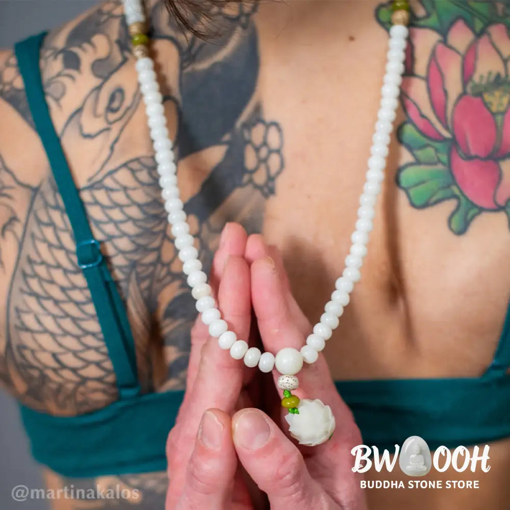 BWOOOH Bodhi Lotus Mala necklace, handcrafted with 108 natural Bodhi seeds (mix of 6x8mm and 8x10mm) and a central, delicate Lotus flower pendant. This spiritual meditation tool, designed for serenity and mindfulness, is artfully displayed with its accompanying gift message card. Promotes enlightenment, peace, and resilience. - View 18