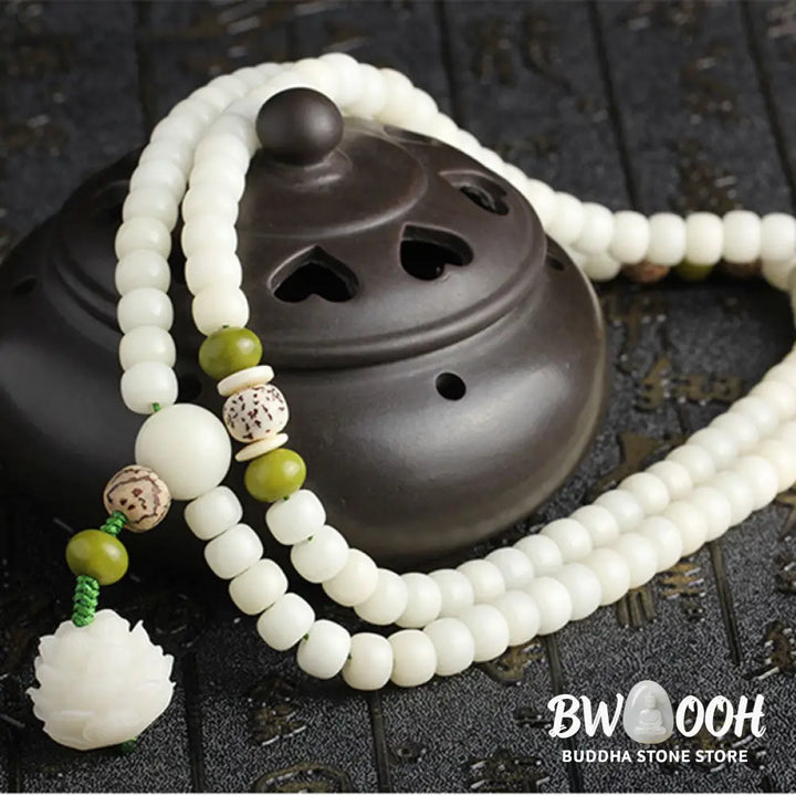 BWOOOH Bodhi Lotus Mala necklace, handcrafted with 108 natural Bodhi seeds (mix of 6x8mm and 8x10mm) and a central, delicate Lotus flower pendant. This spiritual meditation tool, designed for serenity and mindfulness, is artfully displayed with its accompanying gift message card. Promotes enlightenment, peace, and resilience. - View 31