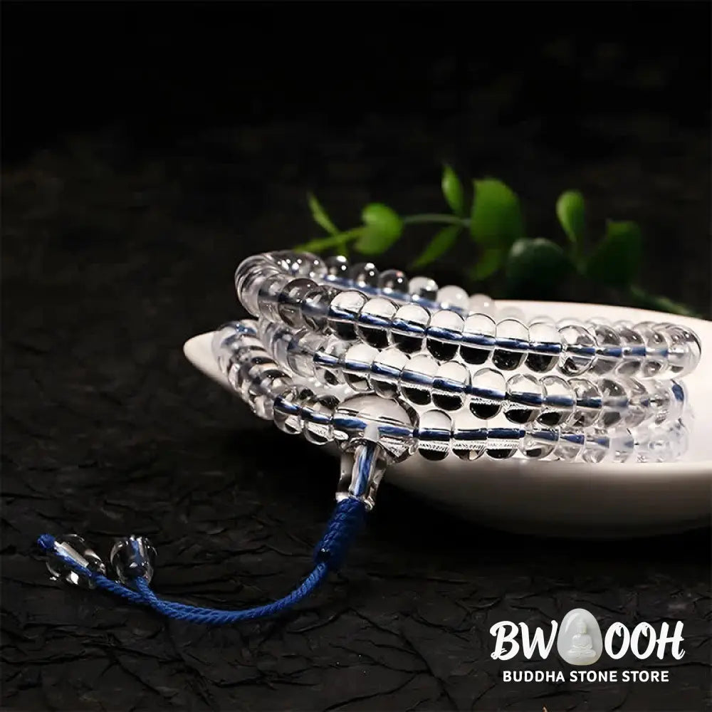 A BWOOOH Liuli 108 Flat Beads Spiral Rope Wisdom Mala, featuring translucent, multi-colored Liuli glass beads crafted with incense ash. The mala is shown wrapped several times around a wrist, ready for meditation and spiritual focus. - View 3
