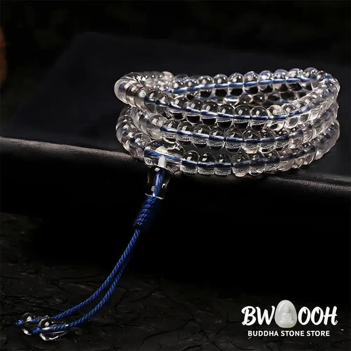 A BWOOOH Liuli 108 Flat Beads Spiral Rope Wisdom Mala, featuring translucent, multi-colored Liuli glass beads crafted with incense ash. The mala is shown wrapped several times around a wrist, ready for meditation and spiritual focus. - View 2