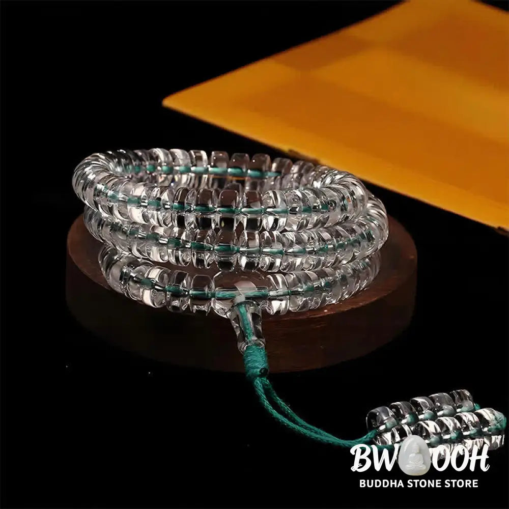A BWOOOH Liuli 108 Flat Beads Spiral Rope Wisdom Mala, featuring translucent, multi-colored Liuli glass beads crafted with incense ash. The mala is shown wrapped several times around a wrist, ready for meditation and spiritual focus. - View 7