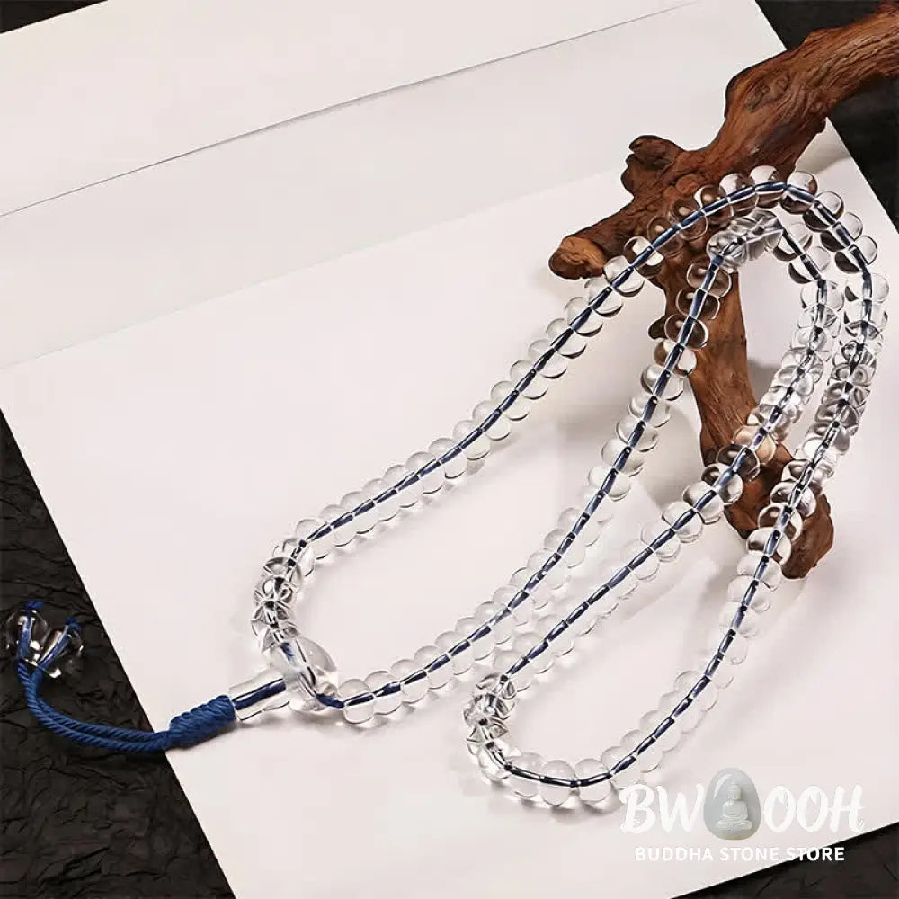 A BWOOOH Liuli 108 Flat Beads Spiral Rope Wisdom Mala, featuring translucent, multi-colored Liuli glass beads crafted with incense ash. The mala is shown wrapped several times around a wrist, ready for meditation and spiritual focus. - View 4