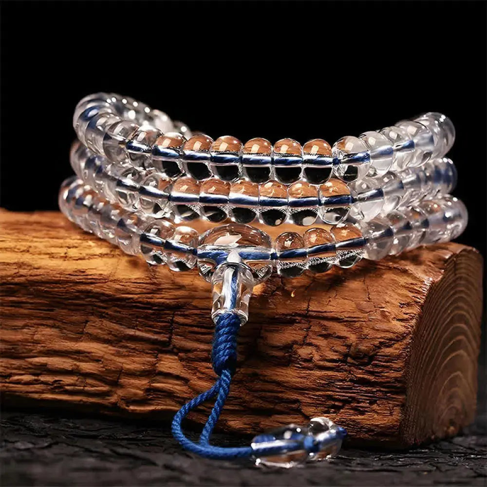 A BWOOOH Liuli 108 Flat Beads Spiral Rope Wisdom Mala, featuring translucent, multi-colored Liuli glass beads crafted with incense ash. The mala is shown wrapped several times around a wrist, ready for meditation and spiritual focus.