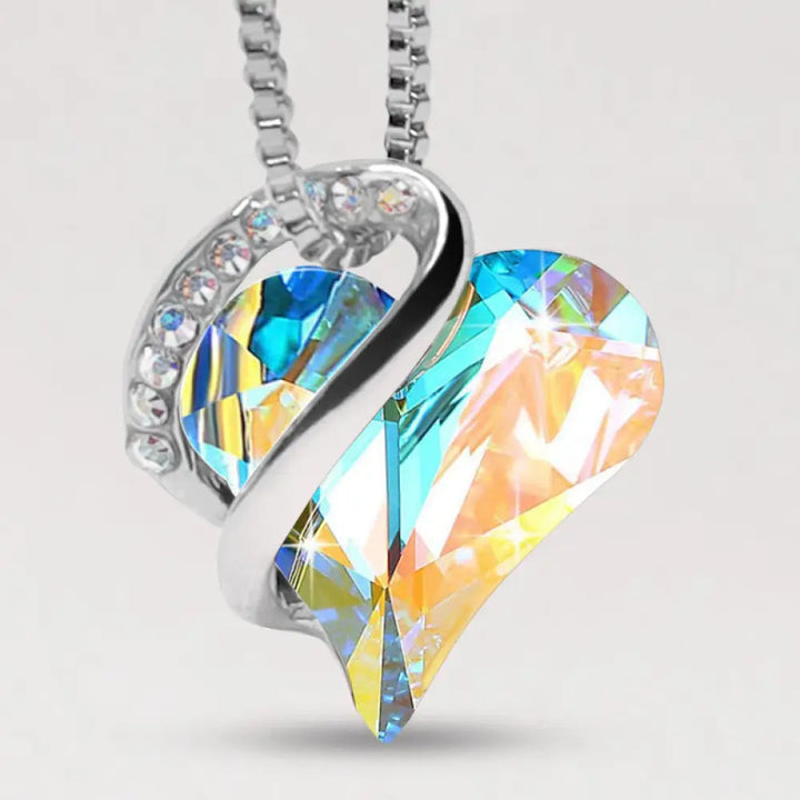 A BWOOOH Love Heart Birthstone Necklace pendant featuring a vibrant, wild-heart-shaped premium crystal, elegantly embraced by a silver-tone ribbon forming an infinity symbol, symbolizing triumph of love and eternal spiritual connection. - View 15