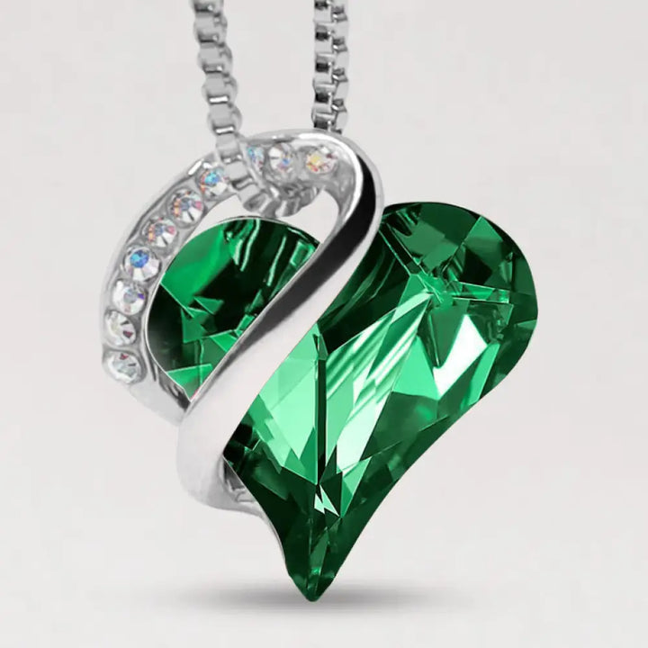 A BWOOOH Love Heart Birthstone Necklace pendant featuring a vibrant, wild-heart-shaped premium crystal, elegantly embraced by a silver-tone ribbon forming an infinity symbol, symbolizing triumph of love and eternal spiritual connection. - View 19