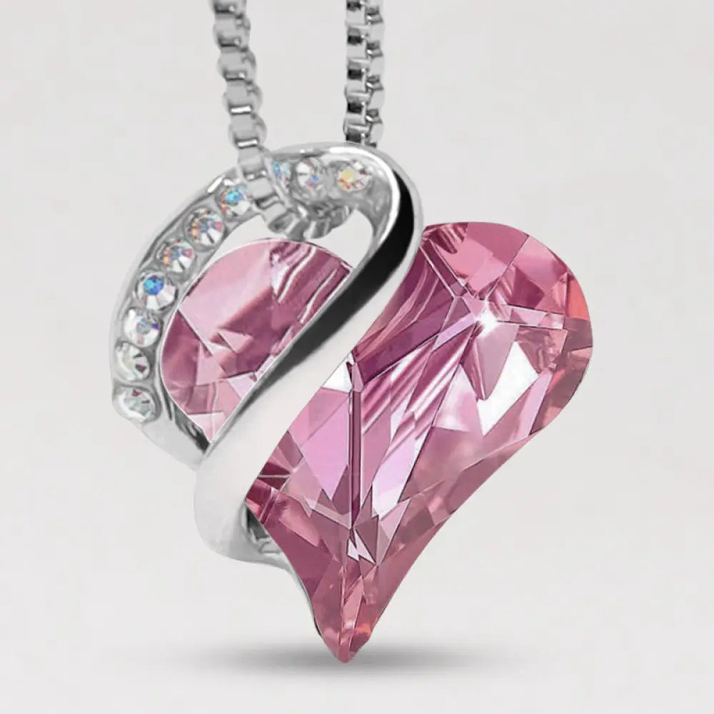 A BWOOOH Love Heart Birthstone Necklace pendant featuring a vibrant, wild-heart-shaped premium crystal, elegantly embraced by a silver-tone ribbon forming an infinity symbol, symbolizing triumph of love and eternal spiritual connection. - View 35