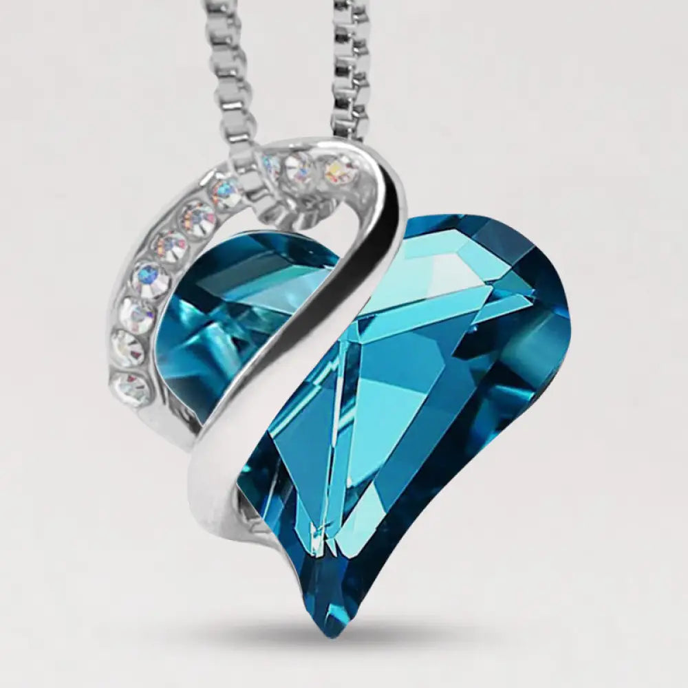 A BWOOOH Love Heart Birthstone Necklace pendant featuring a vibrant, wild-heart-shaped premium crystal, elegantly embraced by a silver-tone ribbon forming an infinity symbol, symbolizing triumph of love and eternal spiritual connection. - View 42