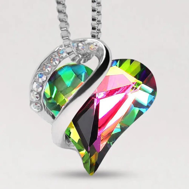 A BWOOOH Love Heart Birthstone Necklace pendant featuring a vibrant, wild-heart-shaped premium crystal, elegantly embraced by a silver-tone ribbon forming an infinity symbol, symbolizing triumph of love and eternal spiritual connection. - View 46