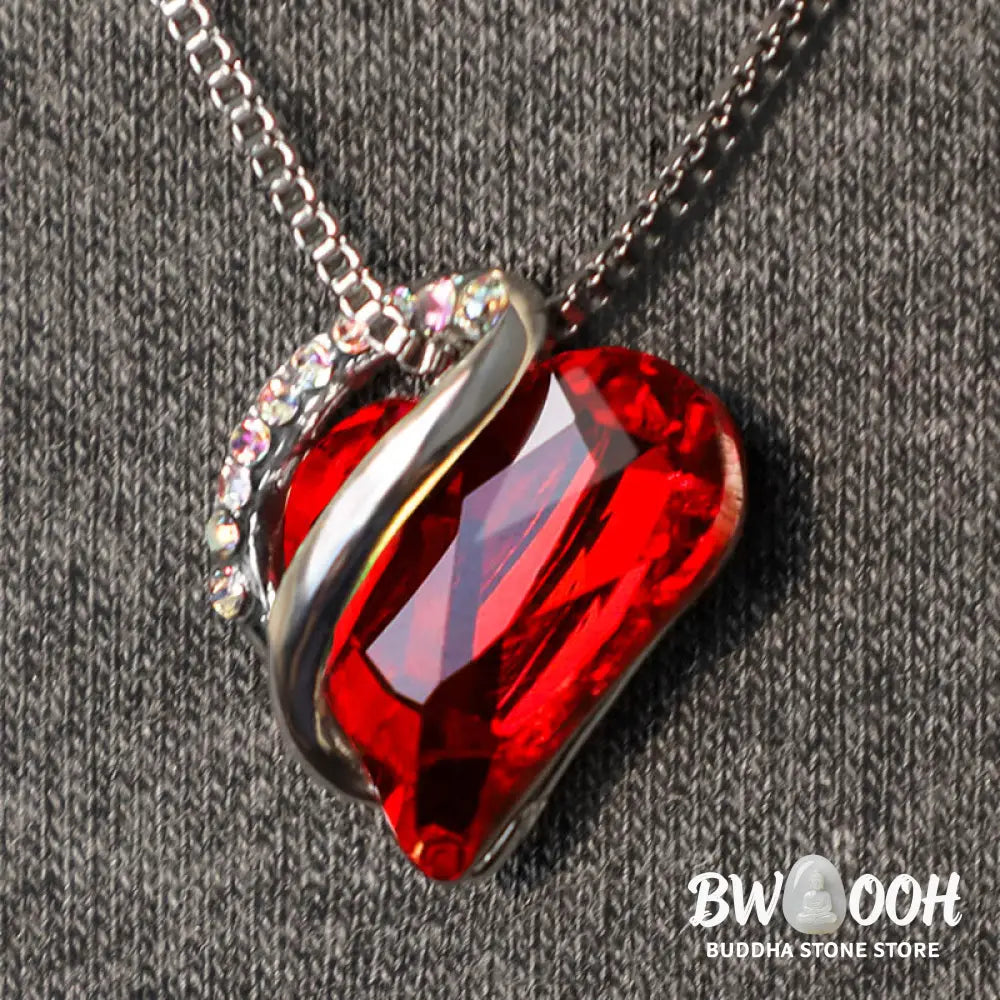 A BWOOOH Love Heart Birthstone Necklace pendant featuring a vibrant, wild-heart-shaped premium crystal, elegantly embraced by a silver-tone ribbon forming an infinity symbol, symbolizing triumph of love and eternal spiritual connection. - View 6