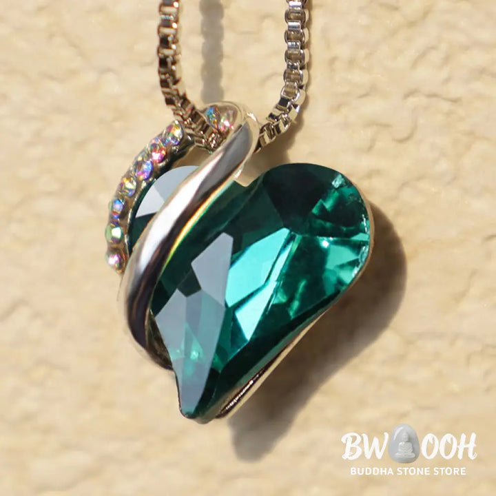 A BWOOOH Love Heart Birthstone Necklace pendant featuring a vibrant, wild-heart-shaped premium crystal, elegantly embraced by a silver-tone ribbon forming an infinity symbol, symbolizing triumph of love and eternal spiritual connection. - View 21