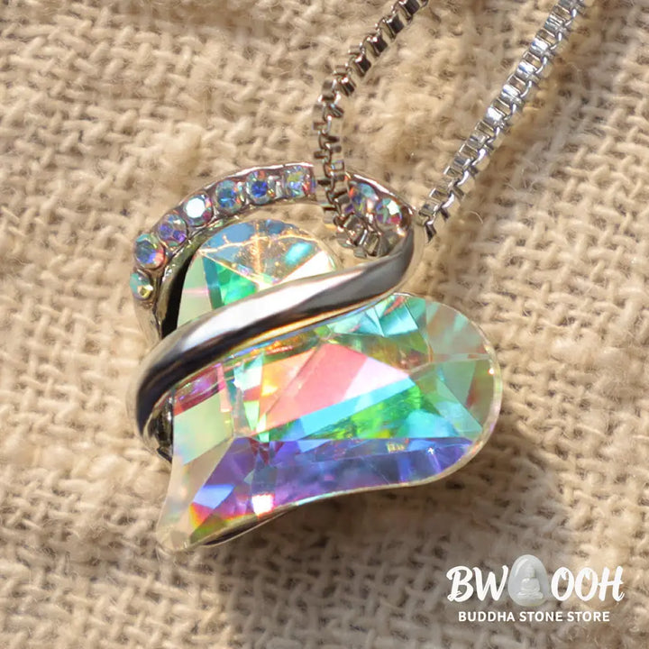 A BWOOOH Love Heart Birthstone Necklace pendant featuring a vibrant, wild-heart-shaped premium crystal, elegantly embraced by a silver-tone ribbon forming an infinity symbol, symbolizing triumph of love and eternal spiritual connection. - View 16