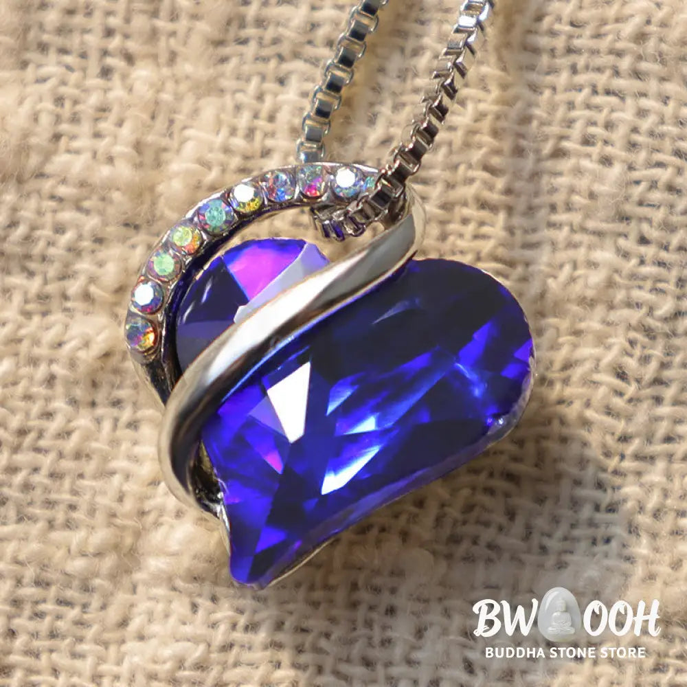 A BWOOOH Love Heart Birthstone Necklace pendant featuring a vibrant, wild-heart-shaped premium crystal, elegantly embraced by a silver-tone ribbon forming an infinity symbol, symbolizing triumph of love and eternal spiritual connection. - View 33