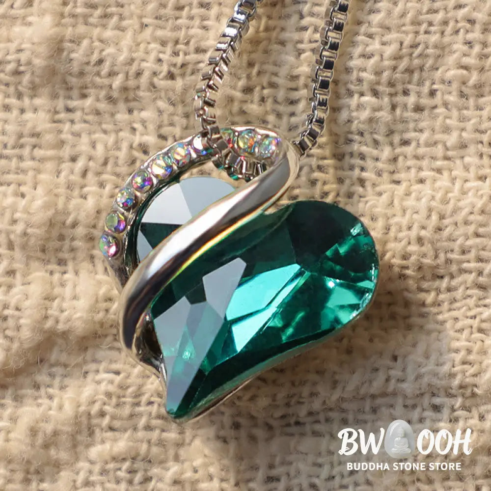 A BWOOOH Love Heart Birthstone Necklace pendant featuring a vibrant, wild-heart-shaped premium crystal, elegantly embraced by a silver-tone ribbon forming an infinity symbol, symbolizing triumph of love and eternal spiritual connection. - View 20