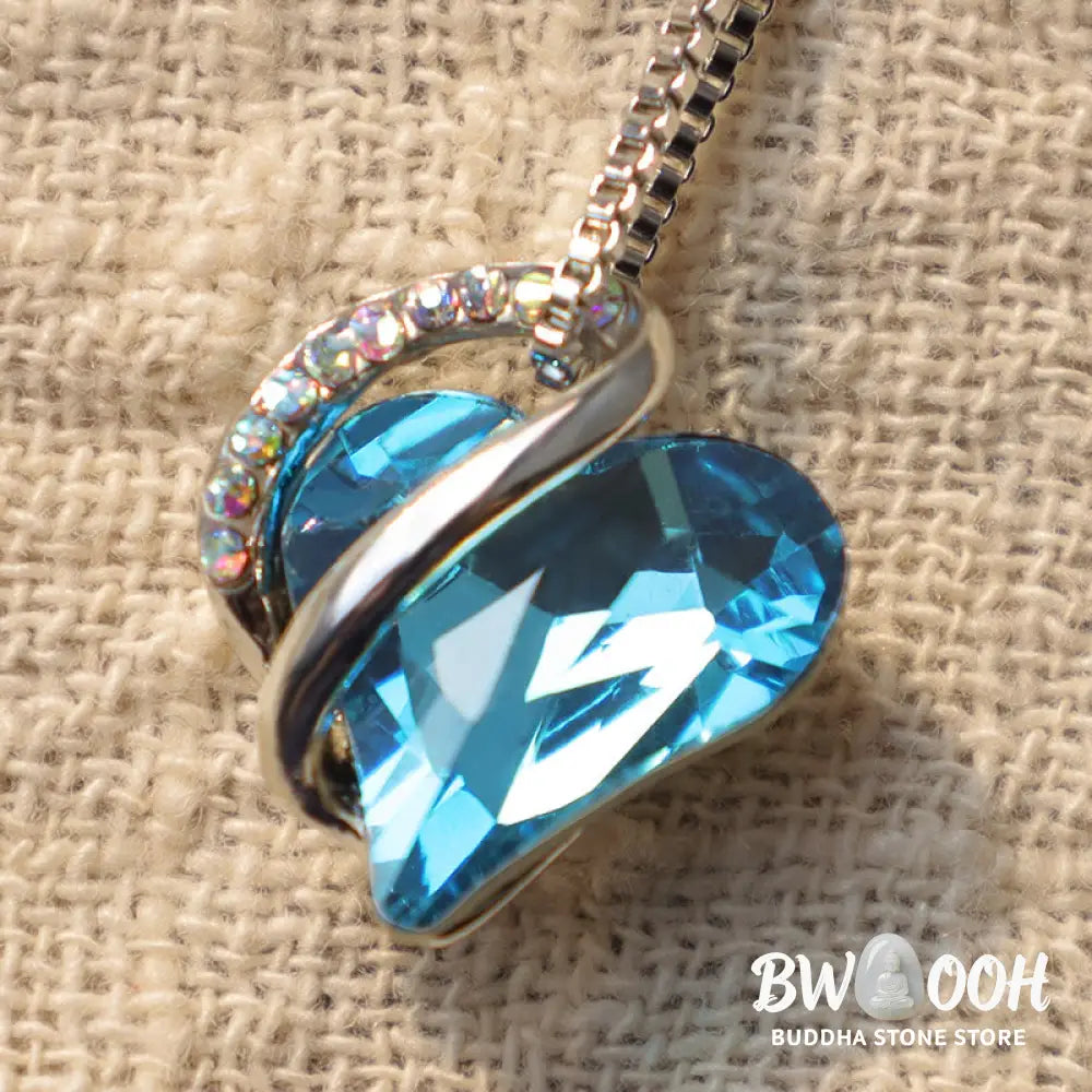 A BWOOOH Love Heart Birthstone Necklace pendant featuring a vibrant, wild-heart-shaped premium crystal, elegantly embraced by a silver-tone ribbon forming an infinity symbol, symbolizing triumph of love and eternal spiritual connection. - View 43