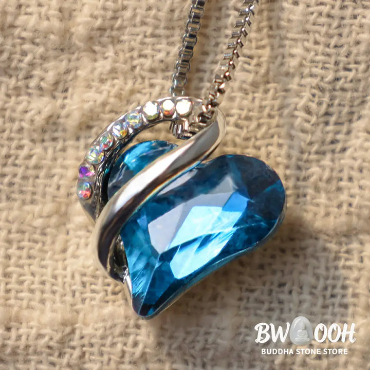 A BWOOOH Love Heart Birthstone Necklace pendant featuring a vibrant, wild-heart-shaped premium crystal, elegantly embraced by a silver-tone ribbon forming an infinity symbol, symbolizing triumph of love and eternal spiritual connection. - View 30