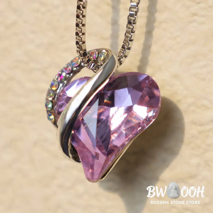 A BWOOOH Love Heart Birthstone Necklace pendant featuring a vibrant, wild-heart-shaped premium crystal, elegantly embraced by a silver-tone ribbon forming an infinity symbol, symbolizing triumph of love and eternal spiritual connection. - View 25